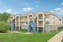 Charming multi-story apartment complex with spacious balconies, lush greenery, and a welcoming atmosphere under a clear blue sky.