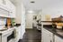 Charming apartment kitchen with modern appliances, sleek countertops, and inviting open layout.