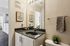 Chic bathroom with modern vanity, elegant leopard print towel, and contemporary art, offering a stylish and inviting atmosphere.