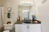 Elegant bathroom featuring a sleek black countertop, modern lighting, and stylish decor for a relaxing ambiance.