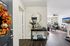 Inviting apartment entryway with fall-themed decor leading into a bright, spacious living area featuring modern furnishings and stylish accents.