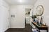 Charming apartment entryway featuring elegant decor, a stylish console table, and convenient laundry room access.