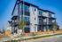 Stylish three-story townhouse with modern architecture, large windows, and balconies.