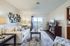 Bright and stylish living room with a cozy sofa, elegant decor, and large glass door leading to a balcony.