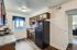 Inviting kitchen with modern appliances, brown cabinets, and a bright window view.