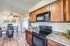 Beautiful kitchen with wooden cabinets, black appliances, and a cozy dining space.