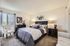 Luxurious bedroom with modern decor, plush bedding, and ambient lighting.