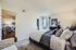 Inviting bedroom with elegant decor and a cozy layout, connected to a bright living room.