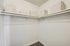 Generous-sized closet with organized storage bins and hanging rods.