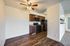 Modern apartment kitchen with sleek appliances and elegant wooden cabinets.