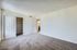 Bright and spacious bedroom with plush carpet and large closet.
