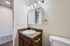 Chic bathroom featuring a modern vanity with a marble countertop, mirror cabinet, and soft lighting.