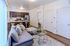Modern apartment interior with open-concept living area, featuring a stylish kitchen with stainless steel appliances, cozy sectional sofa, and elegant decor.