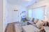 Bright and inviting living room with cozy seating, modern decor, and abundant natural light streaming through large windows.
