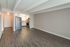 Modern apartment interior with stylish wood flooring, open-concept kitchen with stainless steel appliances, and ample natural light.