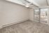 Bright and airy living space with plush carpet and ceiling fan, offering scenic views from the large sliding glass doors.