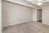Inviting empty room featuring plush carpet flooring and modern ceiling fan, perfect for creating a cozy living space.