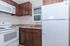 Cozy kitchen with rich wooden cabinets, modern appliances, and granite countertops.