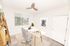 Bright and modern home office with sleek glass desk, ergonomic chair, and chic decor for a productive work environment.