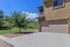 Inviting suburban home with a spacious two-car garage and lush greenery, perfect for modern living.