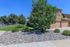 Beautiful suburban home with a charming landscaped garden, featuring lush greenery and neat stone pathways.