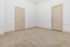 Inviting room with plush carpet flooring, beige doors, and bright white walls, offering a cozy and neutral space perfect for personalization.