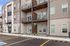 Modern apartment building exterior with private balconies, stylish facade, and convenient parking.