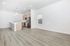 Bright and spacious modern kitchen with sleek stainless steel appliances, elegant light wood cabinetry, and a stylish breakfast bar.