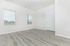 Bright, spacious room featuring sleek hardwood floors and large windows offering serene views.