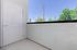 Charming balcony with serene outdoor view, perfect for relaxation and enjoying fresh air.