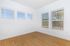 Bright room with elegant wood flooring, large windows, and a serene view, perfect for relaxation.
