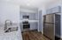 Modern kitchen with sleek stainless steel appliances, elegant granite countertops, and stylish cabinetry, perfect for gourmet cooking.