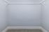 Spacious walk-in closet with sleek white shelving, perfect for ample storage and organization.