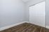 Elegant room featuring sleek hardwood floors and modern sliding closet doors, creating a spacious and contemporary feel.