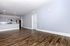 Spacious open-concept apartment with modern kitchen, sleek hardwood floors, and ample natural light.