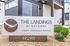 Modern exterior of luxury townhome rentals at The Landings at Gateway with sleek architectural design and attractive signage amid well-maintained landscaping.