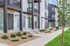 Modern apartment complex showcasing stylish architecture with sleek balconies, smart landscaping, and vibrant front doors for inviting urban living.