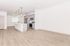 Modern open-concept kitchen with sleek cabinetry and elegant pendant lighting over an island.