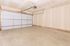 Spacious modern garage with clean white walls and a durable concrete floor, perfect for parking and storage.