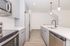 Modern kitchen with elegant pendant lighting and a spacious island for culinary creativity.