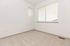 Bright and inviting empty room with large windows, soft carpeting, and clean white walls, perfect for a cozy retreat.