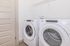 Modern laundry area with sleek Whirlpool washer and dryer set against a crisp white backdrop.