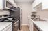 Modern kitchen with elegant marbled countertops and stylish cabinetry, perfect for culinary enthusiasts.