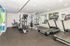 Modern fitness center with state-of-the-art treadmills, elliptical machines, and vibrant wall design for an energetic workout.