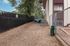 Inviting apartment pet area with sturdy fencing, a shaded bench, and playful agility tunnel for an engaging outdoor experience.