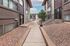 Charming walkway leading to cozy apartment entrances in a well-maintained complex with natural stone landscaping.