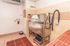 Modern pet spa facility with stainless steel washing station, tiled walls, and convenient grooming tools.