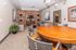 Modern lounge area with stylish wood accents, comfortable seating, and a large round table, perfect for gatherings and relaxation.