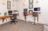 Modern home office space featuring dual workstations, sleek bar stools, and stylish decor.