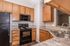 Modern kitchen with elegant wooden cabinets, sleek countertops, and stainless steel appliances ideally suited for culinary enthusiasts.